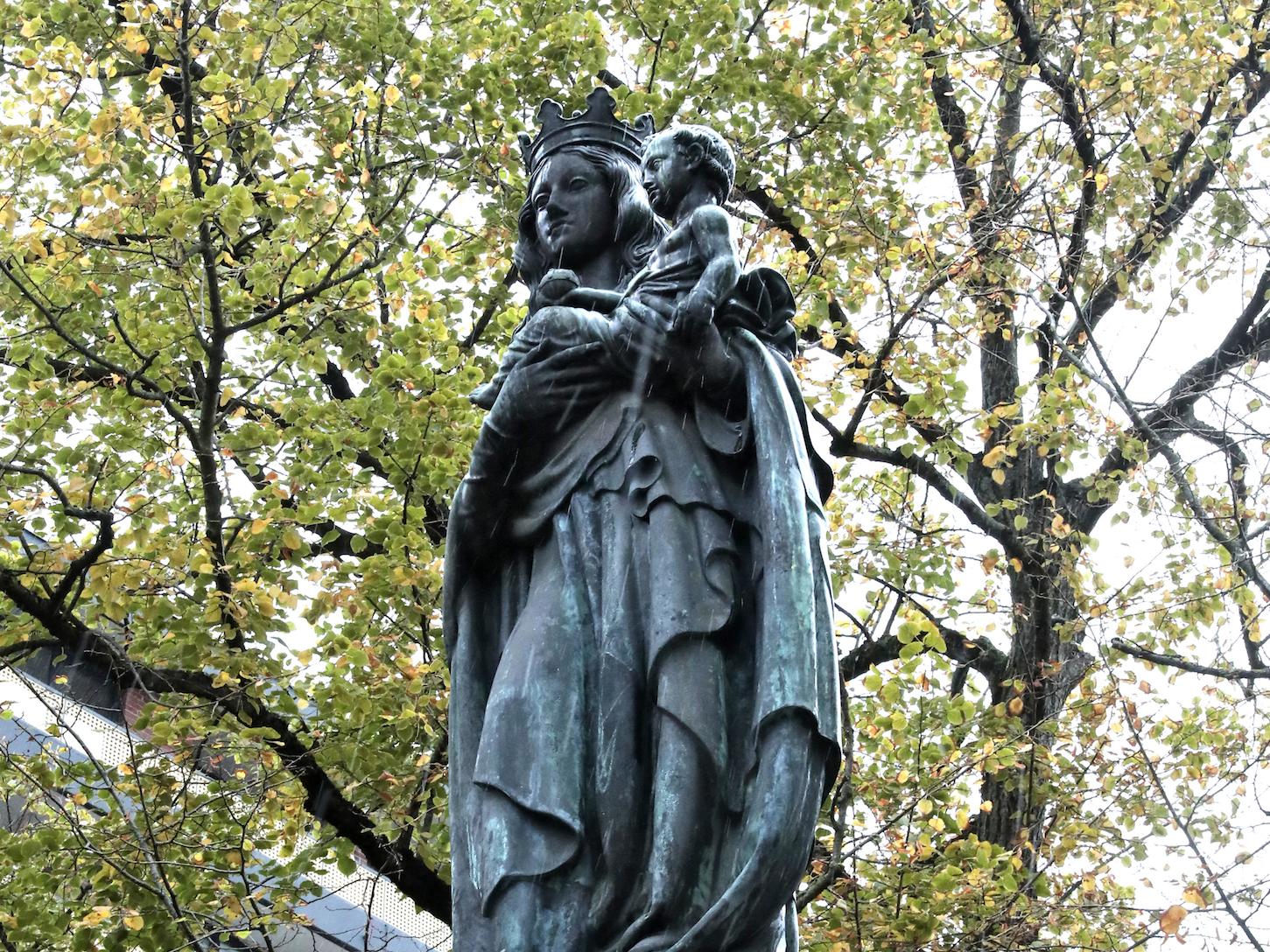 Die bronzene Muttergottes mit dem Christuskind auf dem Arm ist als Friedenskönigin dargestellt.